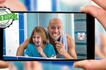 Zahnputz-Apps: Handybildschirm mit Vater und Tochter, die Zähne putzen