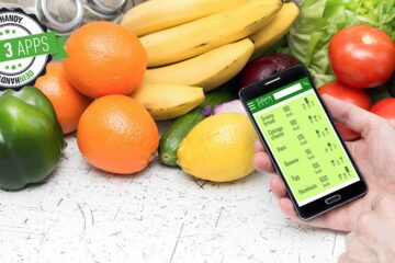 Abnehm-Apps: Handy mit Smartphone, im Hintergrund Obst und Gemüse