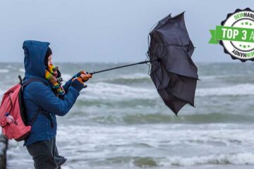 Wind-App: Frau mit Regenschirm im Wind